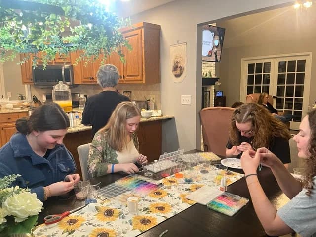 Women making crafts together around the table
